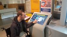 A disabled person using Archives+ at Manchester Central Library