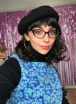 Photo of Ella Clarke with a chic beret on.