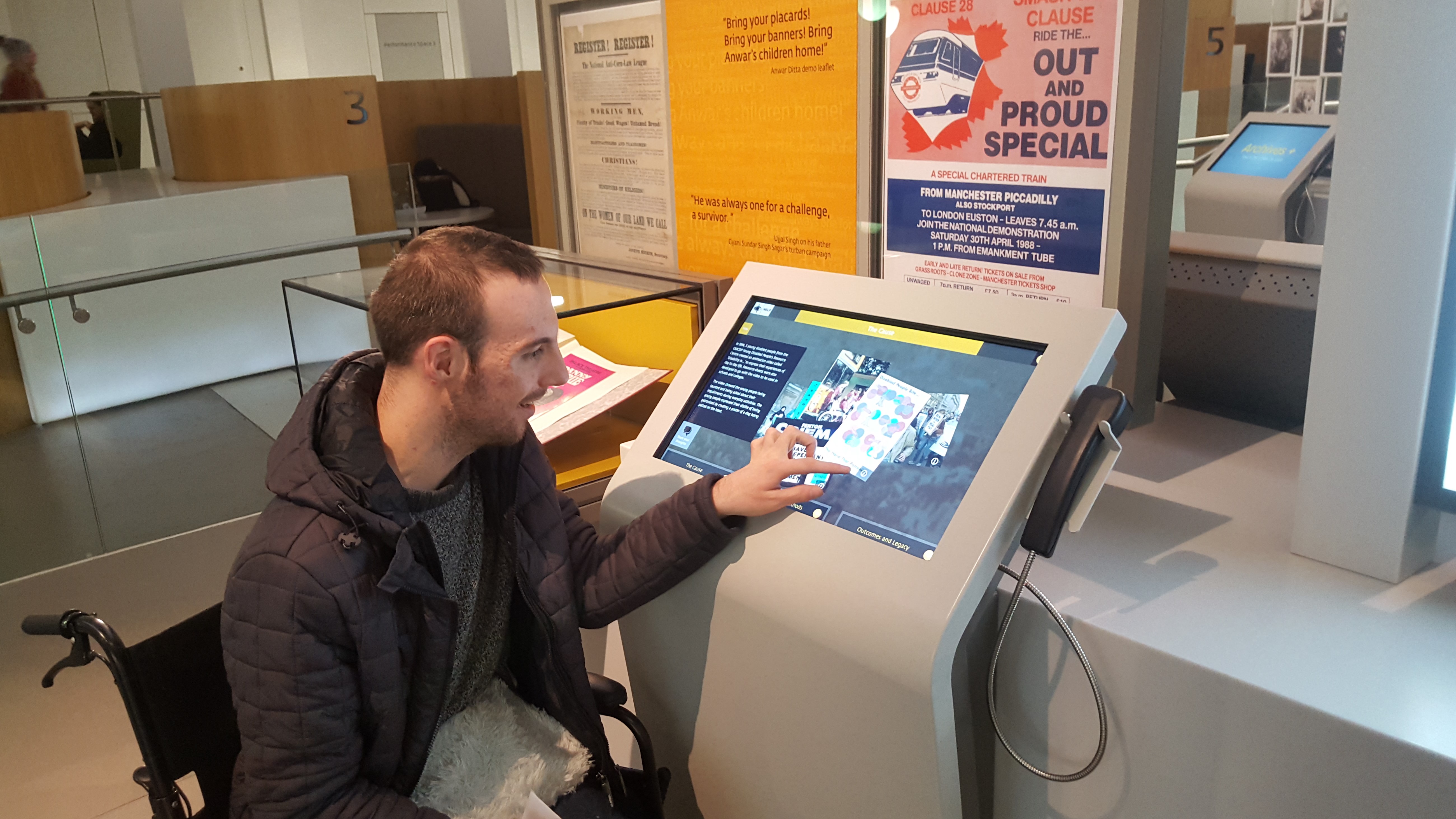 A disabled person using Archives+ at Manchester Central Library